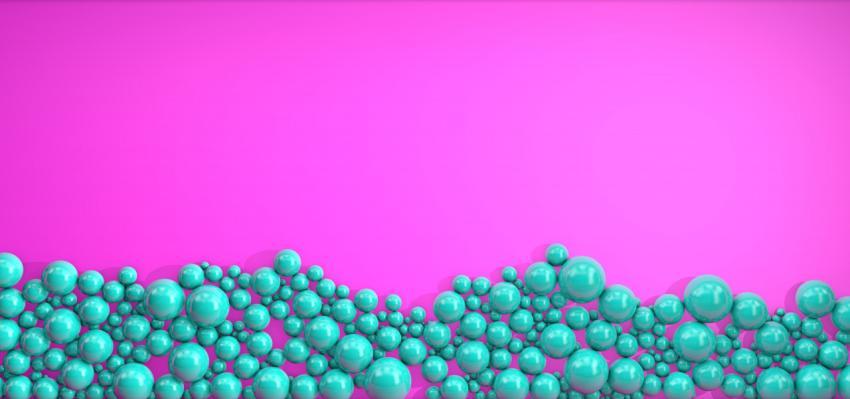 Pearl green balls of different sizes are scattered on a pink background. Modern beautiful background