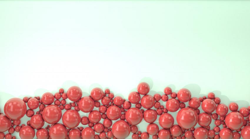 Red pearls of different sizes are scattered on a light background. Modern beautiful background