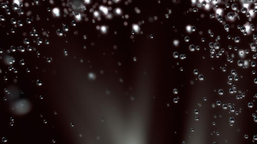 Dark background with air bubbles underwater.