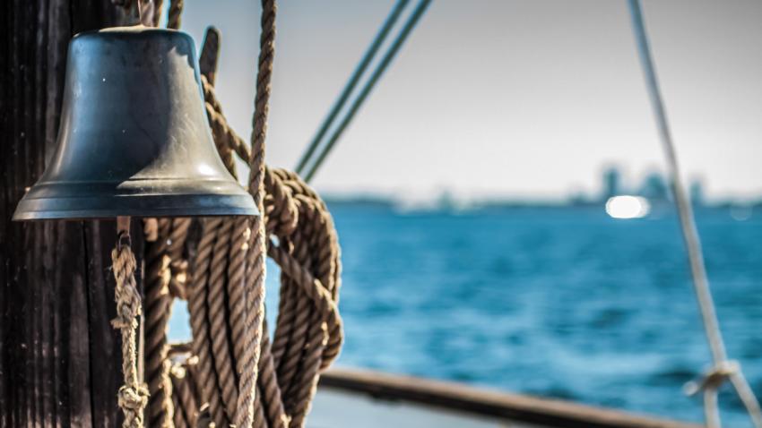 Bell and hanging ropes on cruising yacht