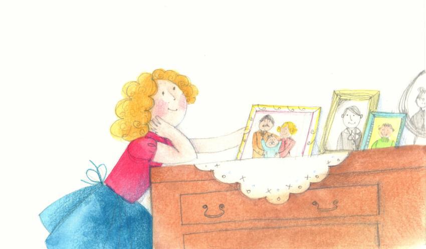 girl looking at family photos