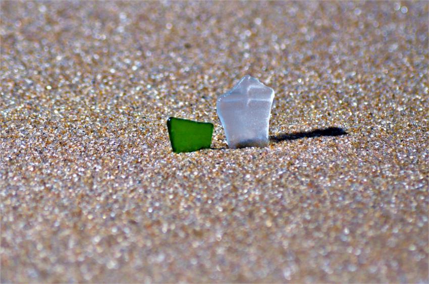 pieces of glass in the sea sand