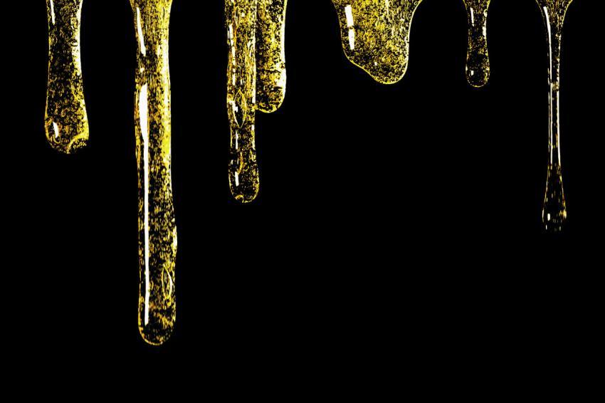 Flowing honey close-up on a black background