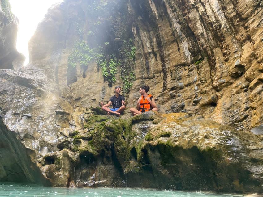 Two people on the rocks near the water