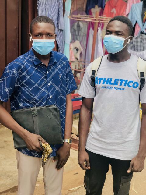 Two black men wearing masks