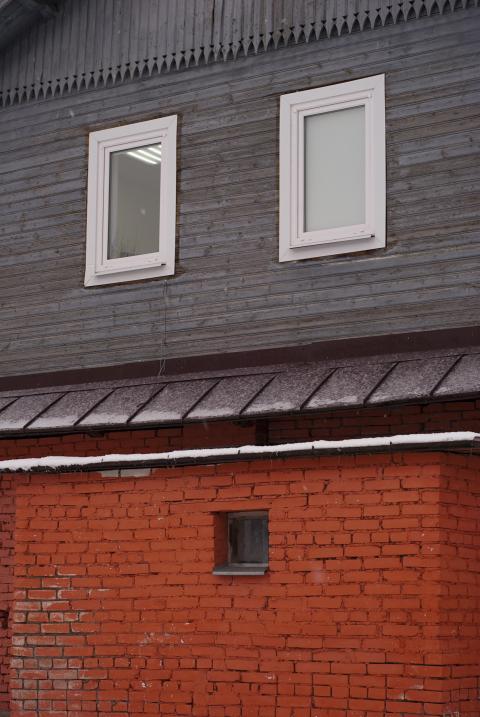 Brickwork and wooden planks in the facade of the building